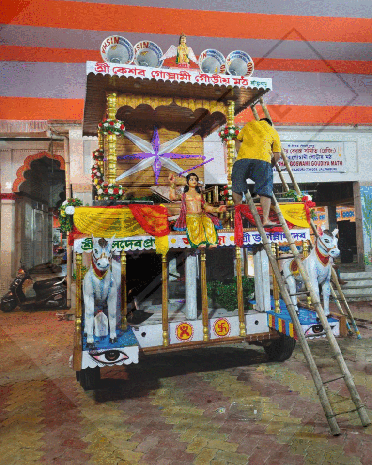 A towering, ornately decorated chariot (rath) adorned with vibrant fabrics and intricate carvings, surrounded by a sea of devotees pulling the ropes and celebrating in the streets during the annual Rath Yatra festival. The atmosphere is filled with energy, devotion, and the spirit of unity as participants from all walks of life join together in this grand tradition.